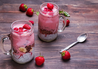 Chia pudding with strawberry and granola on the wooden table clo