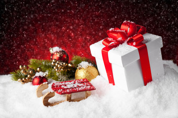 christmas gift with balls bow red background