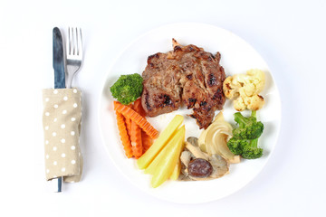 Home made ,Pork steak and mixed vegetables served.