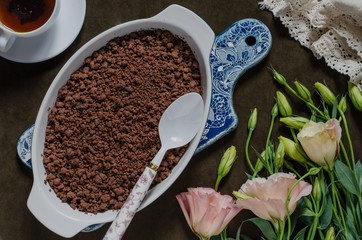 Chocolate crumble with pears and plums and a bunch of flowers