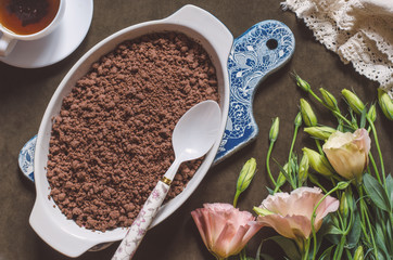 Chocolate crumble with pears and plums and a bunch of flowers