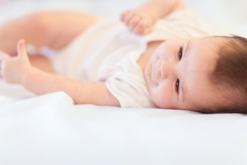Close up portrait of cute baby. Fun happy baby in bedroom. Famil