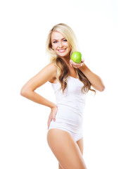 Young and fit woman holding a fresh green apple