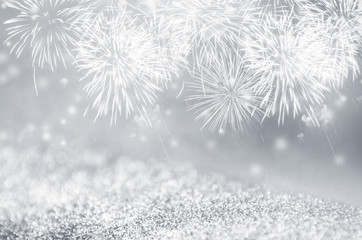 Defocused silver and gray fireworks and bokeh on gliter paper at New Year and copy space. Abstract...