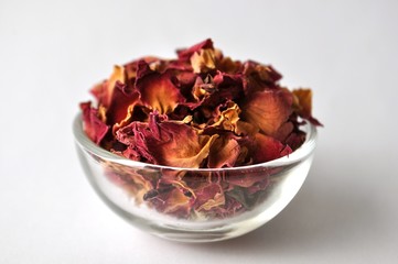 Rose petals in a glass bowl close up with copy space
