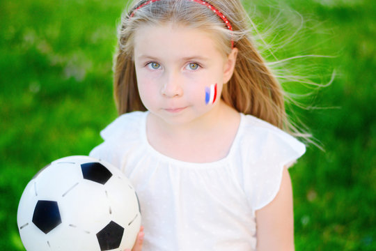 Adorable little girl supporting her national football team during soccer championship