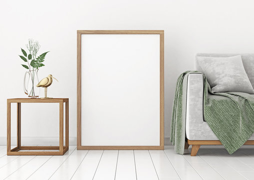 Vertical interior poster mock-up with empty wooden frame and plants on white wall background. 3D rendering.
