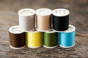 Multi-colored thread on a wooden table