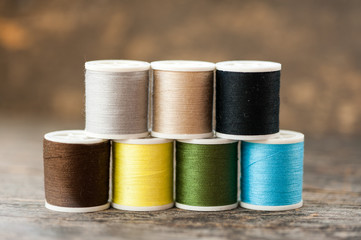 Multi-colored thread on a wooden table