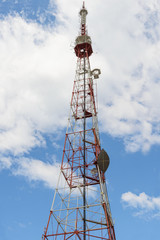 high TV tower with telecommunication equipment on the background