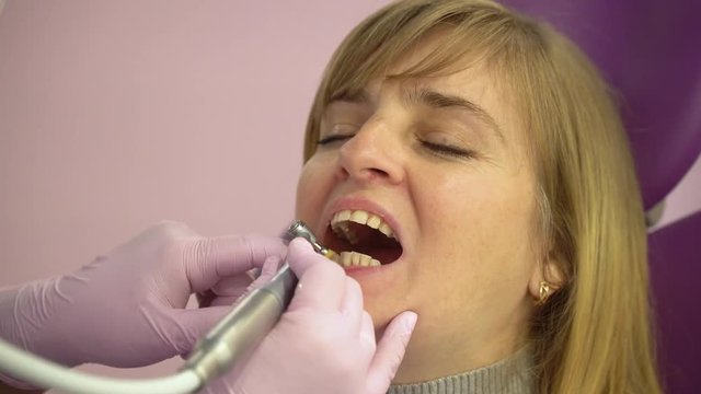 Woman at the dental hygienist and dentist clinic professional tooth whitening. Odontic and mouth health and hygiene is important part of human life that dentistry help with