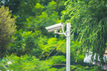 cctv camera in the garden green park background.