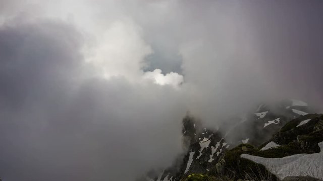 Big clouds over the snow-capped mountain peaks, timelapse