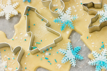Christmas baking background: dough, cookie cutters and snowflake