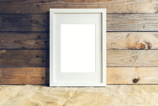White frame and wooden background