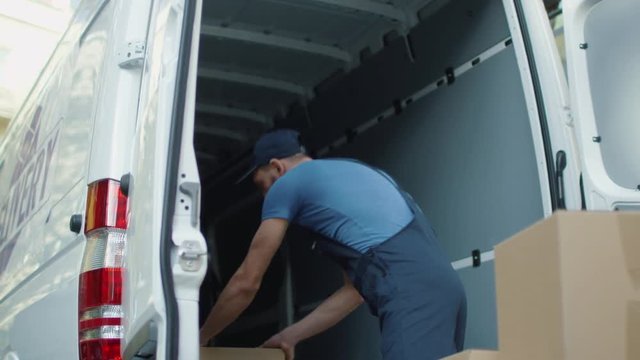 Young Mover Loads his Cargo Van with Cardboard Boxes. Shot on RED Cinema Camera in 4K (UHD).