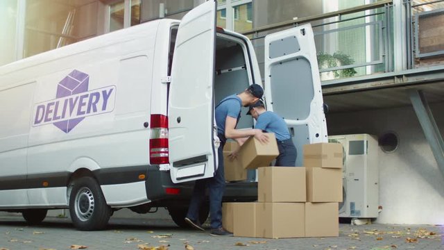 Two Smiling Movers are Loading Cargo Van with Cardboard Boxes in a Modern City. Shot on RED Cinema Camera in 4K (UHD).