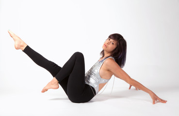 Woman in Silver Leotard and Leggings in Seated Dance Pose