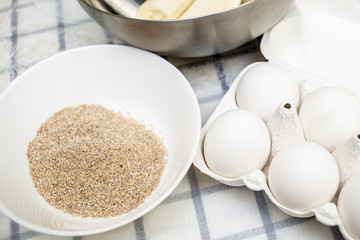 On the table are wheat bran, eggs, bananas ready for cooking dietetic dessert, close-up