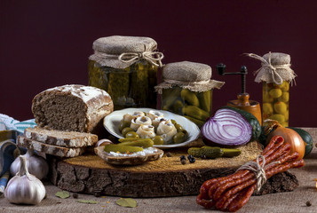 Herrings Pickles. Salted Cucumbers still-life with dark bread