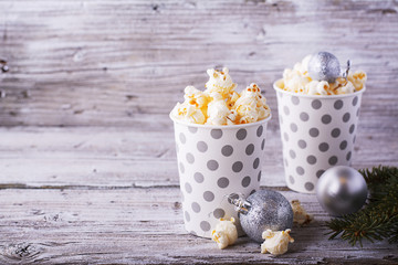 Popcorn in paper cup on white background.