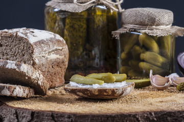 Pickles. Salted Cucumbers still-life with dark bread