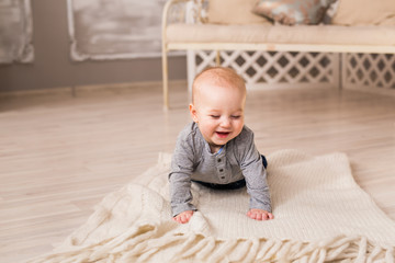 Laughing Baby Boy Lying On Tummy At Home