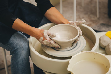 Hands working on pottery wheel