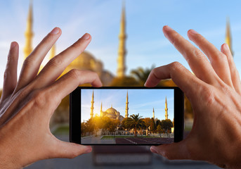 Travel concept. Hand making photo of city with smartphone camera. Istanbul. Turkey