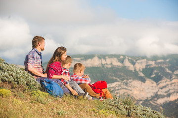 Naklejka na ściany i meble Family of four people looking to beautiful seascape in mountains