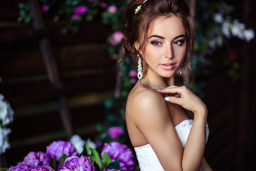 Gorgeous bride young woman in a wedding dress with perfect makeup and hairstyle