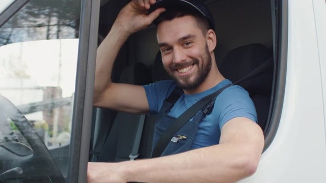 Medium Shot Of A Delivery Man Opening Window of his Cargo Van and Smiling at the Camera. Shot on RED Cinema Camera in 4K (UHD).