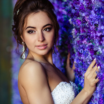 Gorgeous bride young woman in a wedding dress with perfect makeup and hairstyle