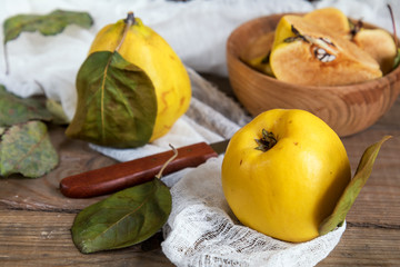 The fresh quince fruit on dark wooden table. An autumn still life.