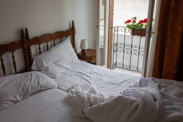 open outspread bed in morning bedroom