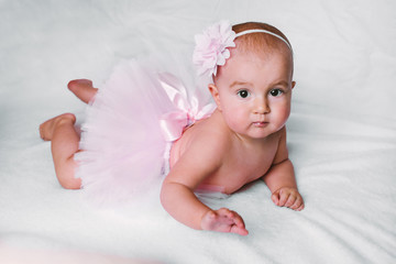 Baby girl wearing a pink tutu © VlaDee