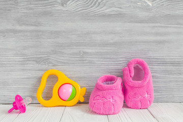 pink booties on wooden background