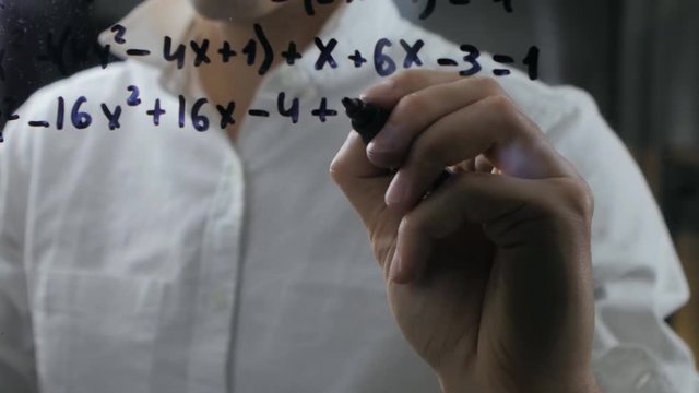 male wrote mathematical formulas on a blackboard