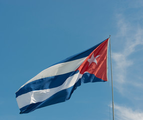 Cuba flag before blue sky and sunshine