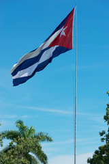 Cuba flag before blue sky and sunshine