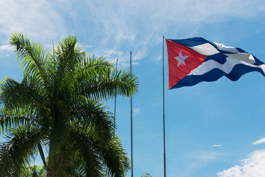 Cuba flag before blue sky and sunshine
