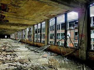 Window frame inside crumbling abandoned factory corridor 