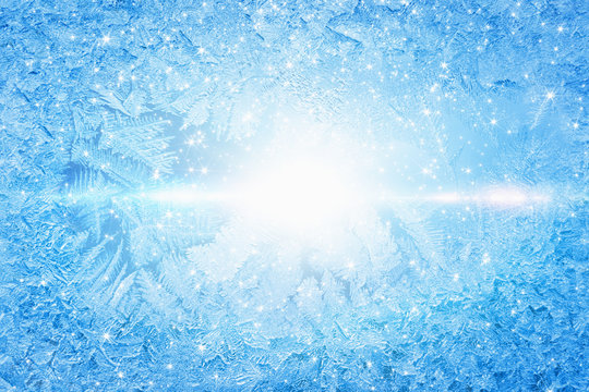 Bright sun shines through frozen window