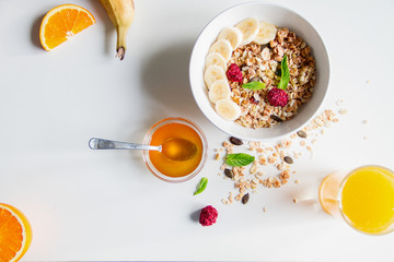 Breakfast with oatmeal and orange juice on white background