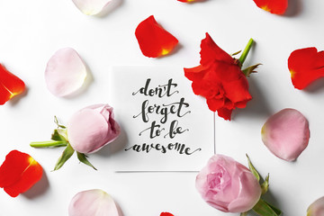 Quote "Dont forget to be awesome" written on paper with petals and flowers. Top view