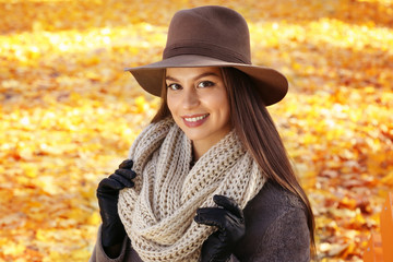 Portrait of beautiful young woman wearing hat in autumn park