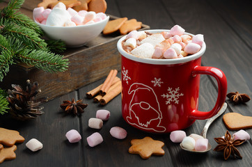 Hot chocolate with marshmallows and spices on dark wooden background. Christmas composition, selective focus.