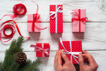 Fototapeta premium Female wrapping Christmas gift box.