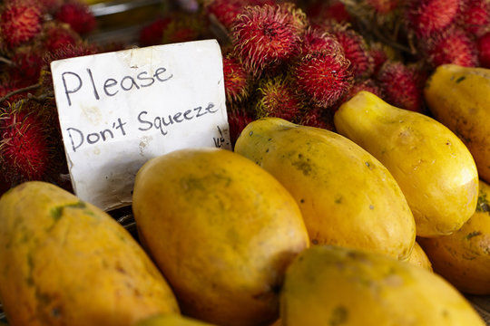 Rambutan and Papaya fruit with don't squeeze sign