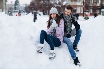 Fototapeta na wymiar Happy stylish couple in winter city on Christmas.